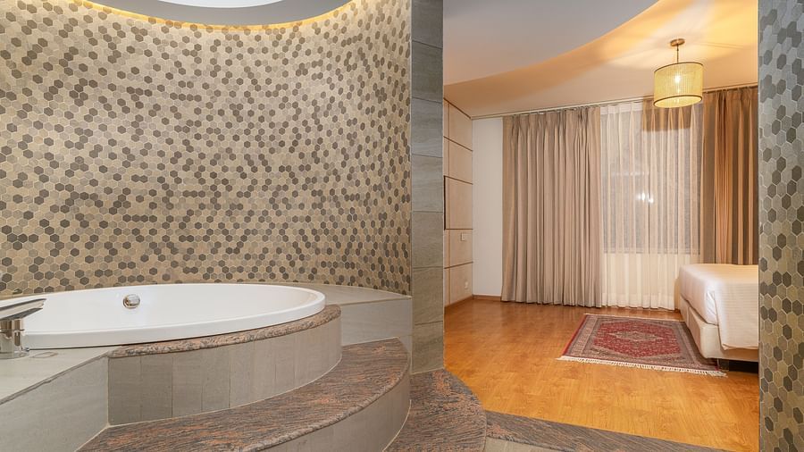 A bathroom in our suite with a lavishly designed circular tub - Sarovar Premiere, Srinagar